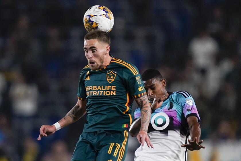 LA Galaxy midfielder Tyler Boyd (11) jumps to head the ball next to Minnesota United midfielder Joseph Rosales during the first half of an MLS soccer match Wednesday, Sept. 20, 2023, in Carson, Calif. (AP Photo/Ryan Sun)