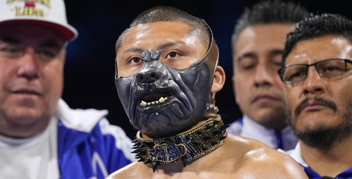 Isaac Cruz wears a dog mask