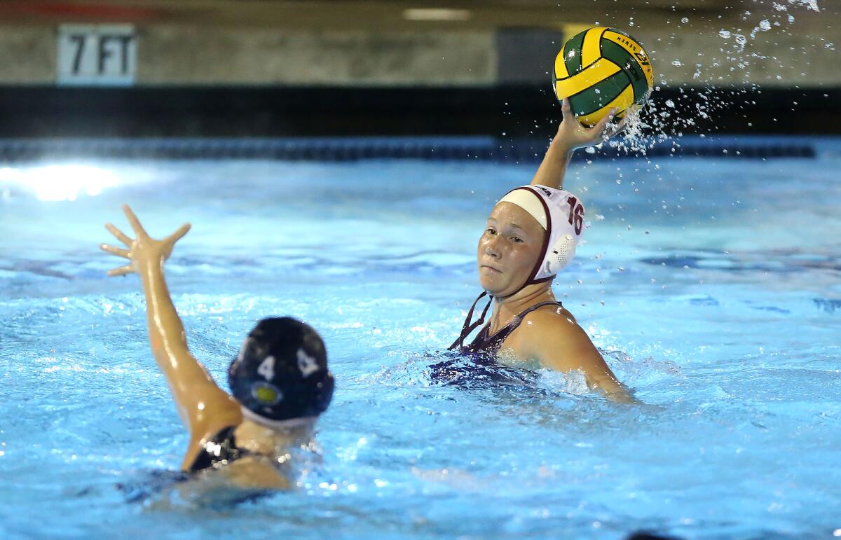 Laguna Beach’s Nicole Struss (16) winds up a shot and scores as Newport Harbor’s Morgan Netherton tries to defend during the semifinals of the CIF Southern Section Division 1 playoffs at Irvine’s Woollett Aquatics Center on Wednesday.