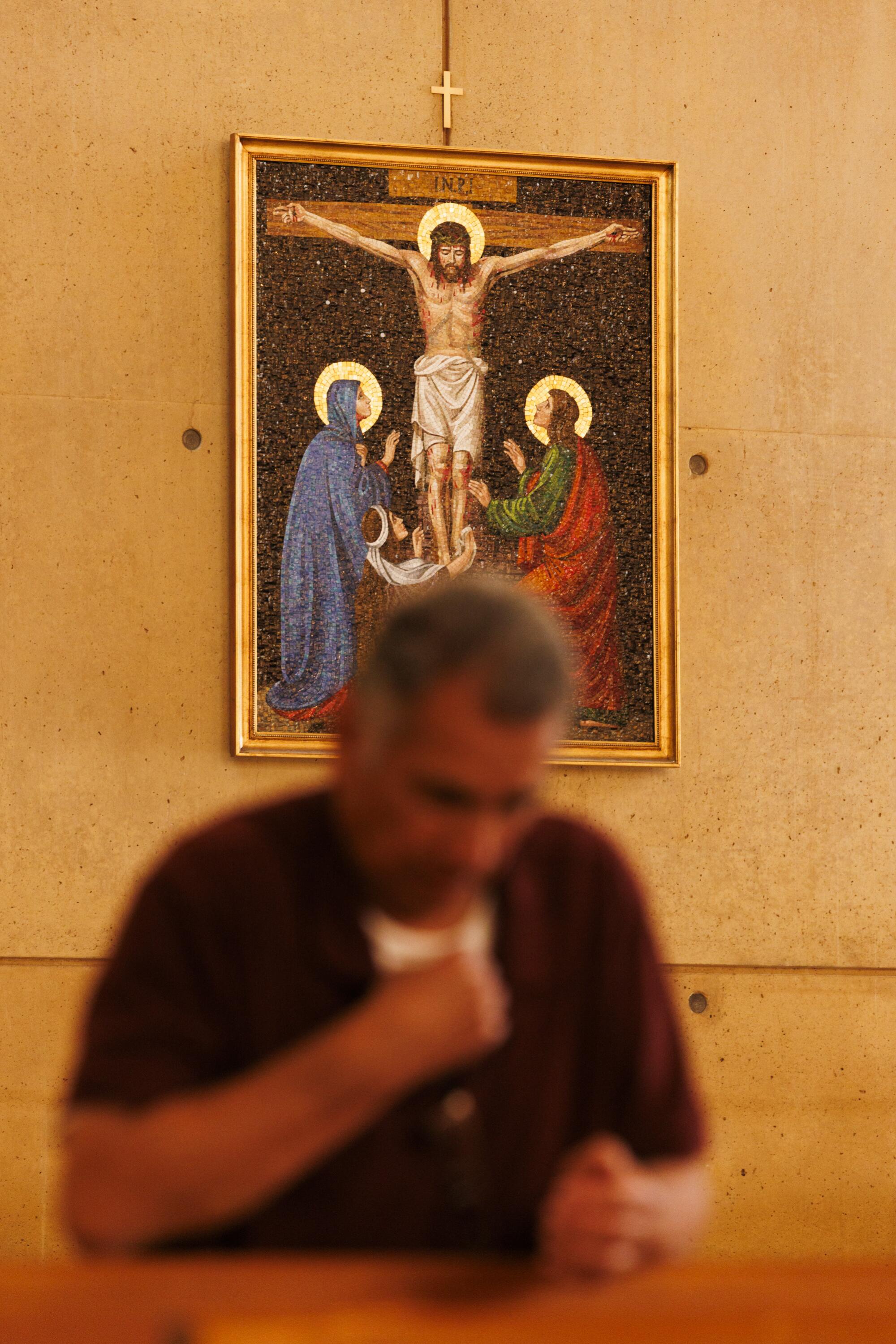 A man prays at the Cathedral of Our Lady of the Angels.