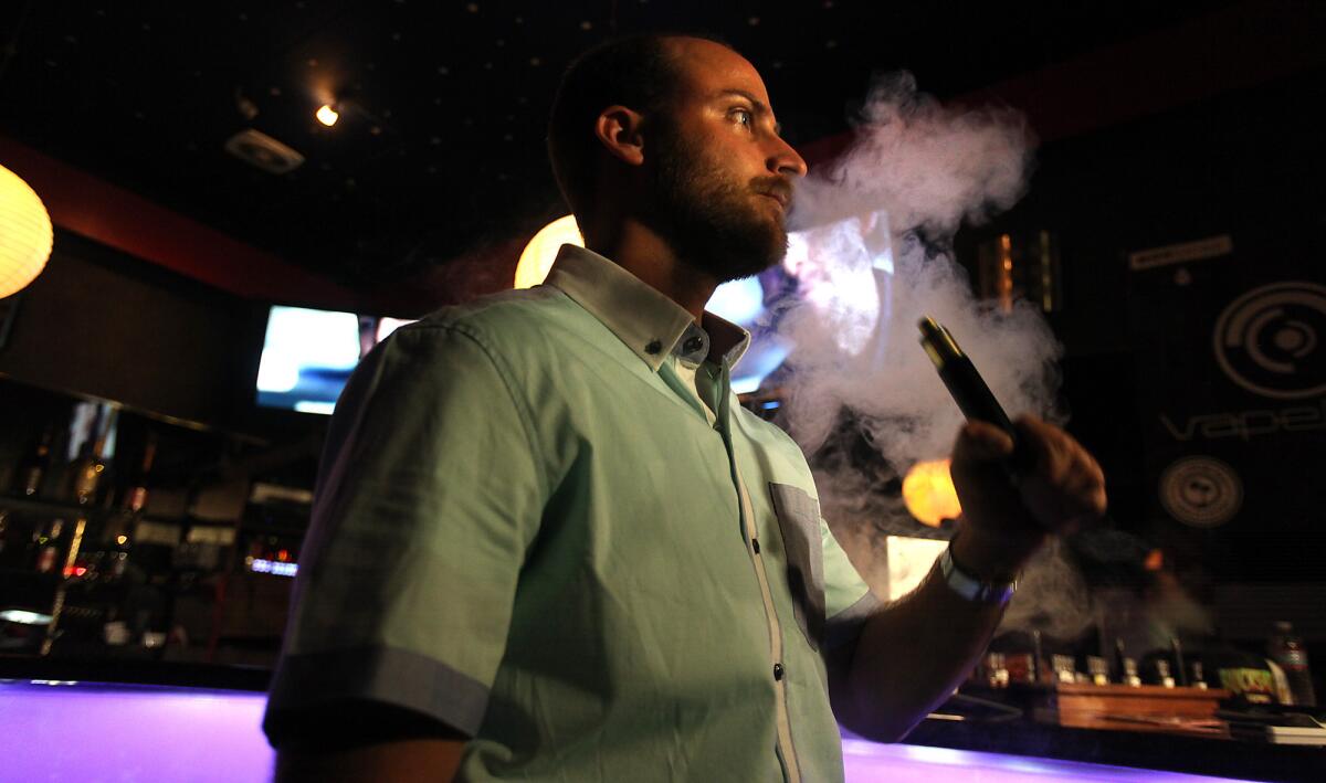 Daren Hiltunen of Santa Monica exhales vapor from a "vape" device at the Cindy Club in Los Angeles on April 18, 2014.