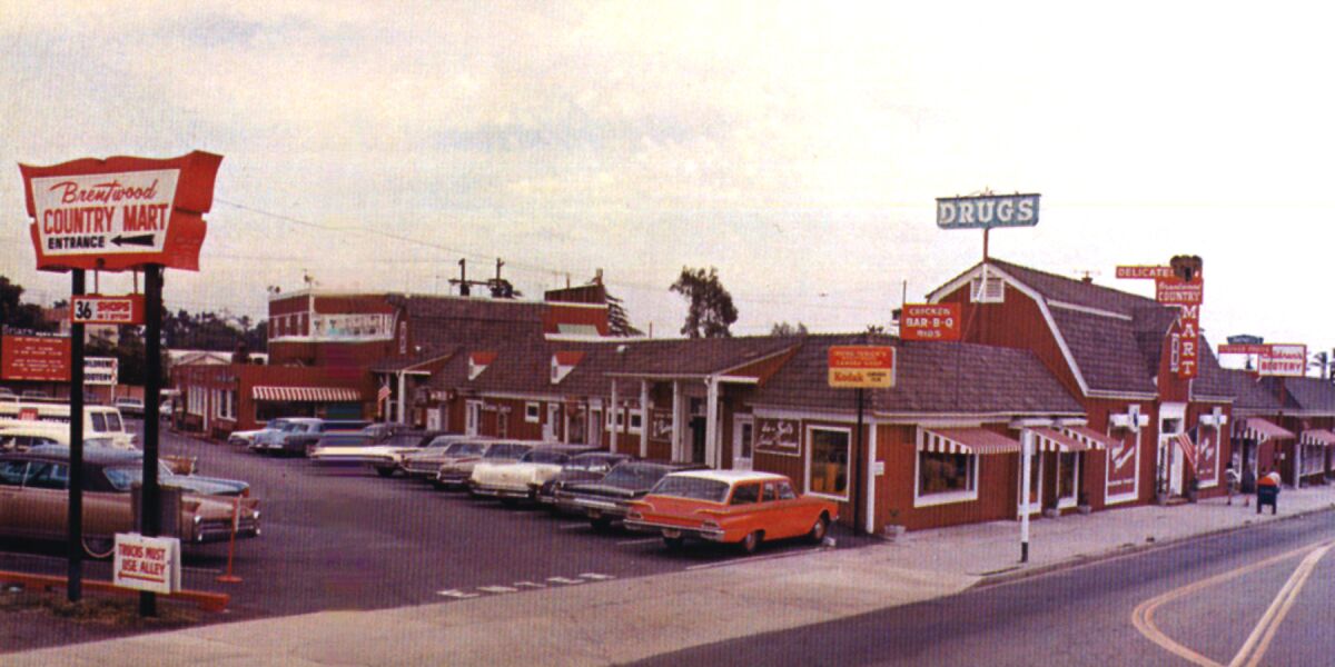 A vintage color photo shows cars parked outside the Brentwood Country Mart.