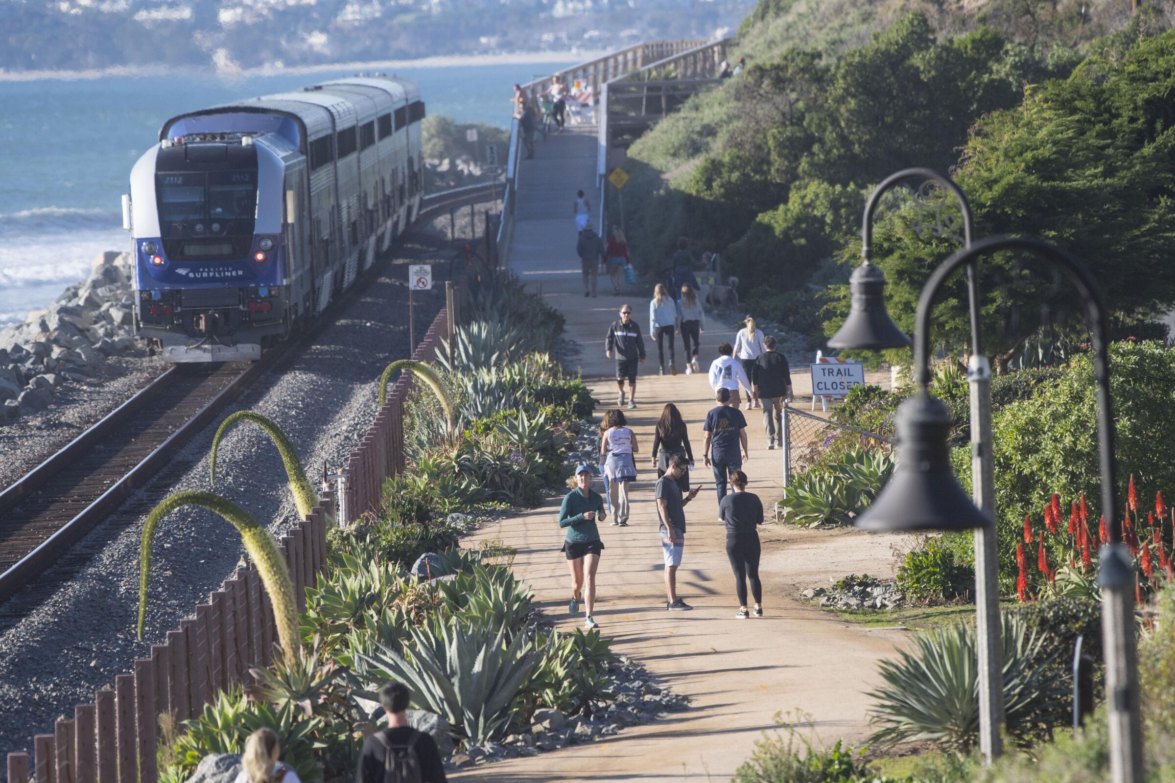 A train runs between the coast and the San Clemente Coastal Trail.