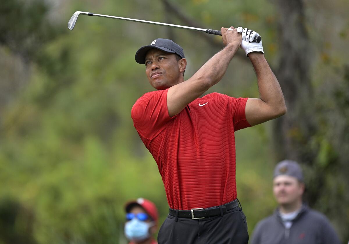 Tiger Woods watches his tee shot on the fourth hole during the final round.