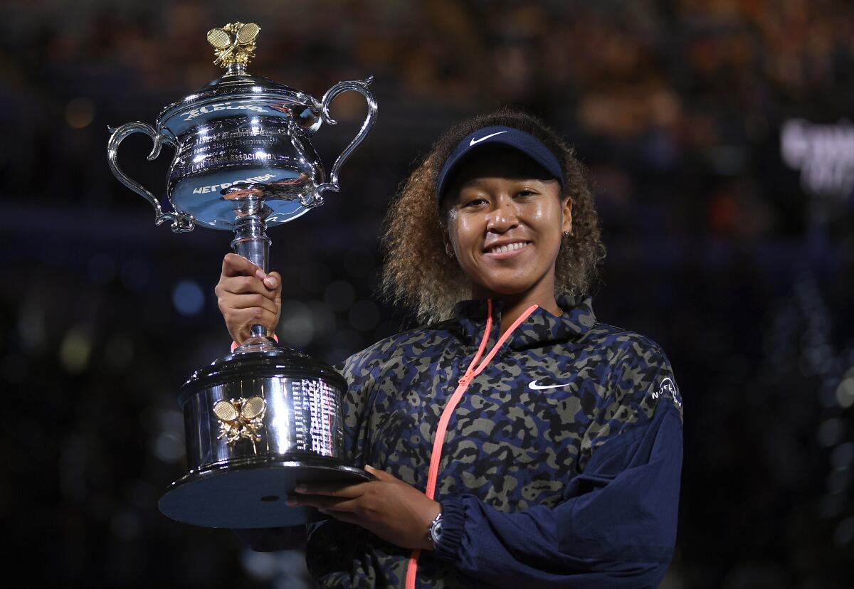 Naomi Osaka holds the Daphne Akhurst Memorial Cup and smiles