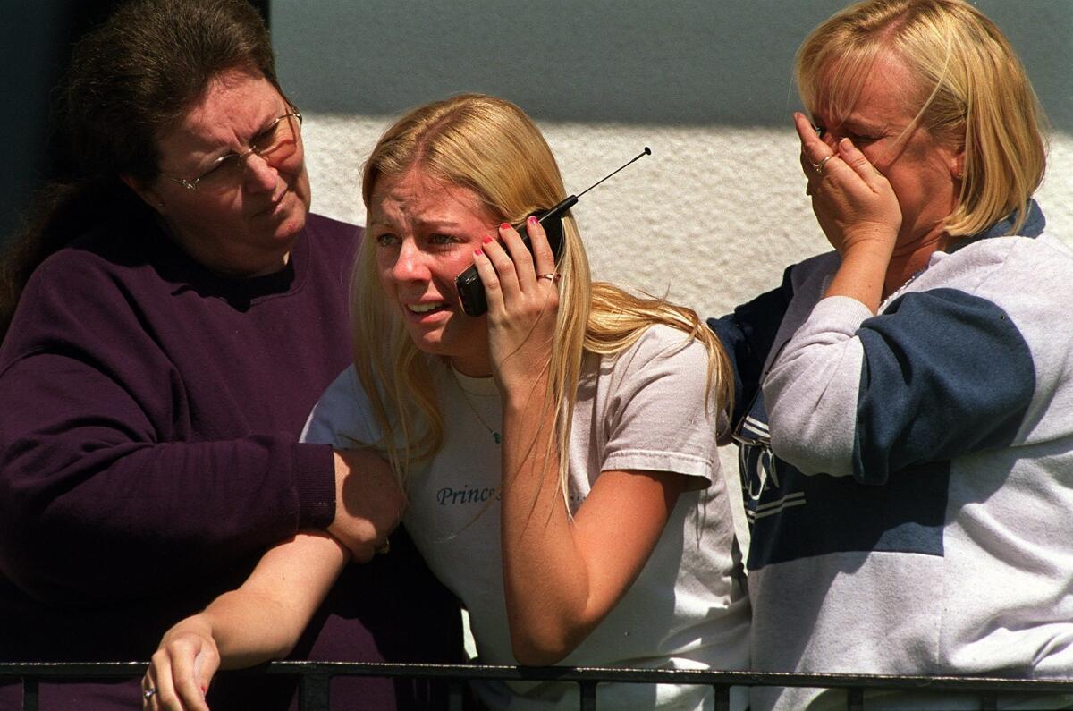 Parent of a Santana High School student, Linda Eyler of El Cajon, comforts Nicolle Aldrich, 17, center, and her mother, Terry Adams, right, as Nicolle finds out that four of her friends were injured in the shooting. (Published 03/06/2001)