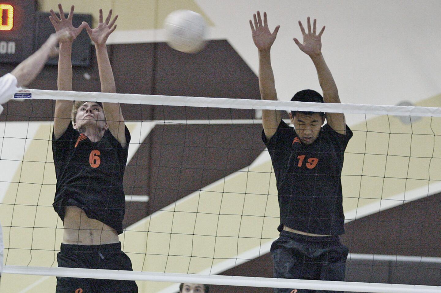 South Pasadena's David Barker, left, and Jason Qiu try to block a spike but miss during a match against St. Francis at St. Francis High School in La Canada on Tuesday, March 26, 2013.