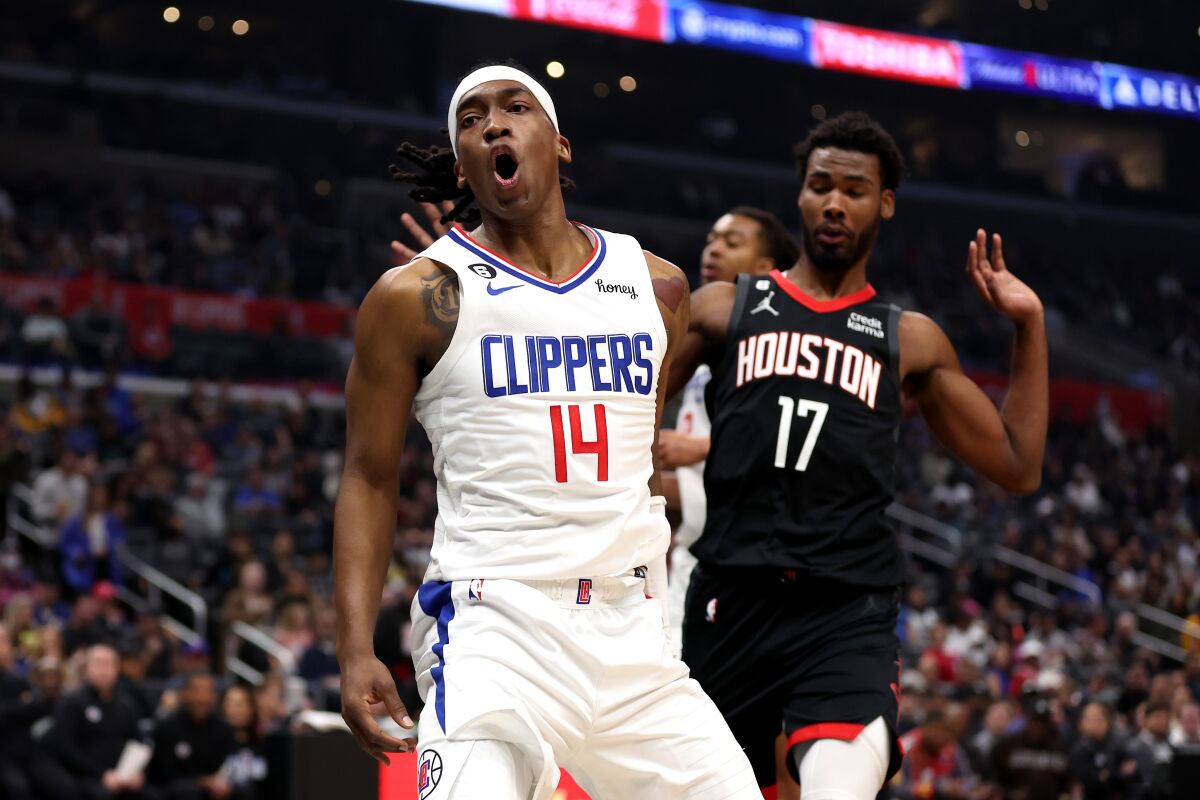 Clippers guard Terance Mann reacts with a yell after scoring against the Rockets on Sunday.