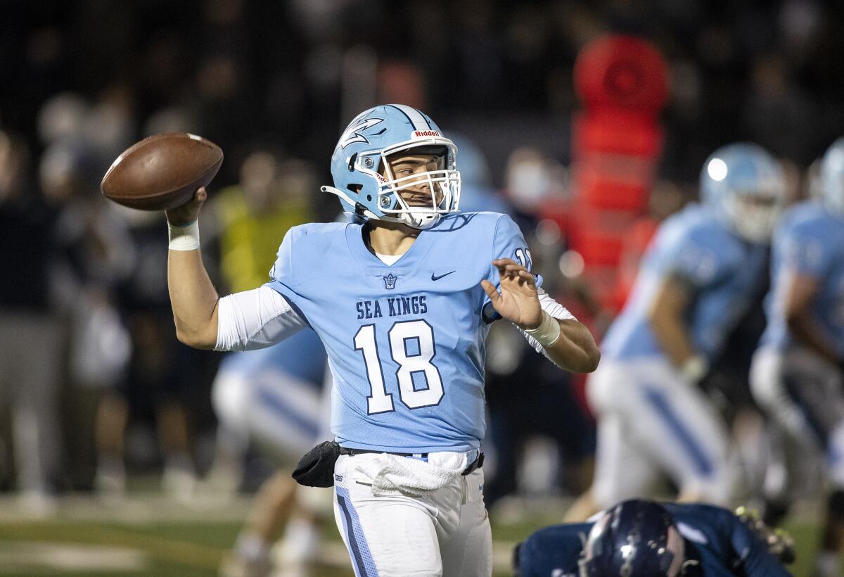 Corona del Mar's David Rasor throws a pass during the Battle of the Bay football game against Newport Harbor on April 2.