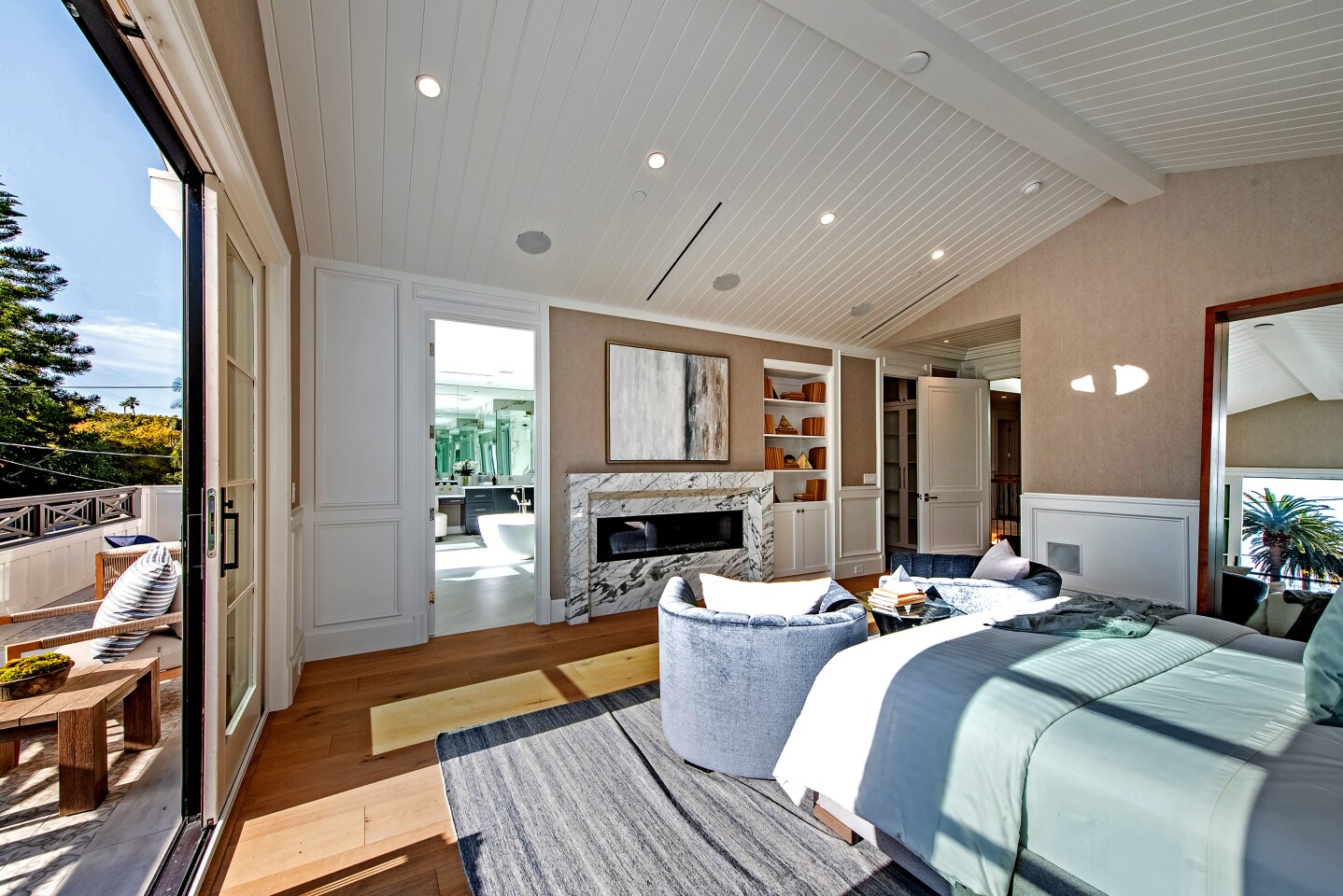 Listed for $8.899 million, the newly built home sits on a tree-lined street in the desirable North of Montana area of Santa Monica. Influenced by East Coast and traditional design styles, the two-story features crisp white walls, detailed wainscoting and multiple fire features. Features of home include an elevator, a media room and a wine cellar. A wet bar fills a side wall in the family room.