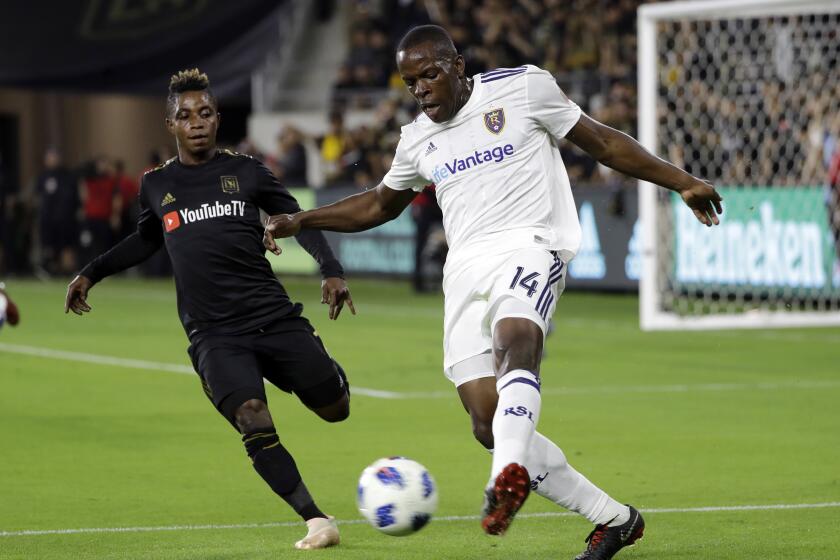 Real Salt Lake's Nedum Onuoha, right, clears the ball as Los Angeles FC's Latif Blessing closes in during the first half of an MLS soccer playoff match Thursday, Nov. 1, 2018, in Los Angeles. (AP Photo/Marcio Jose Sanchez)