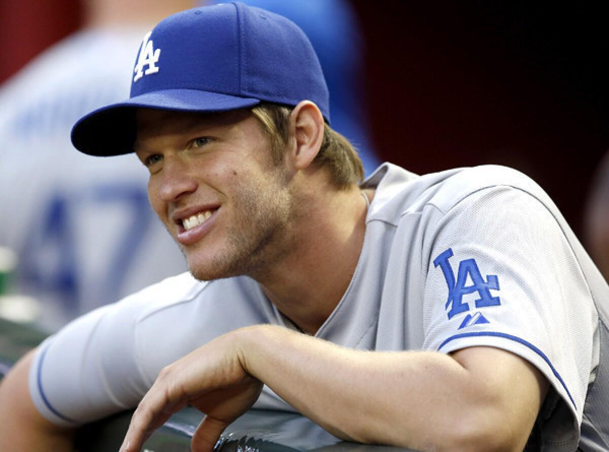 Dodgers pitcher Clayton Kershaw chats with teammates in the dugout before a game against the Arizona Diamondbacks on Friday in Phoenix.