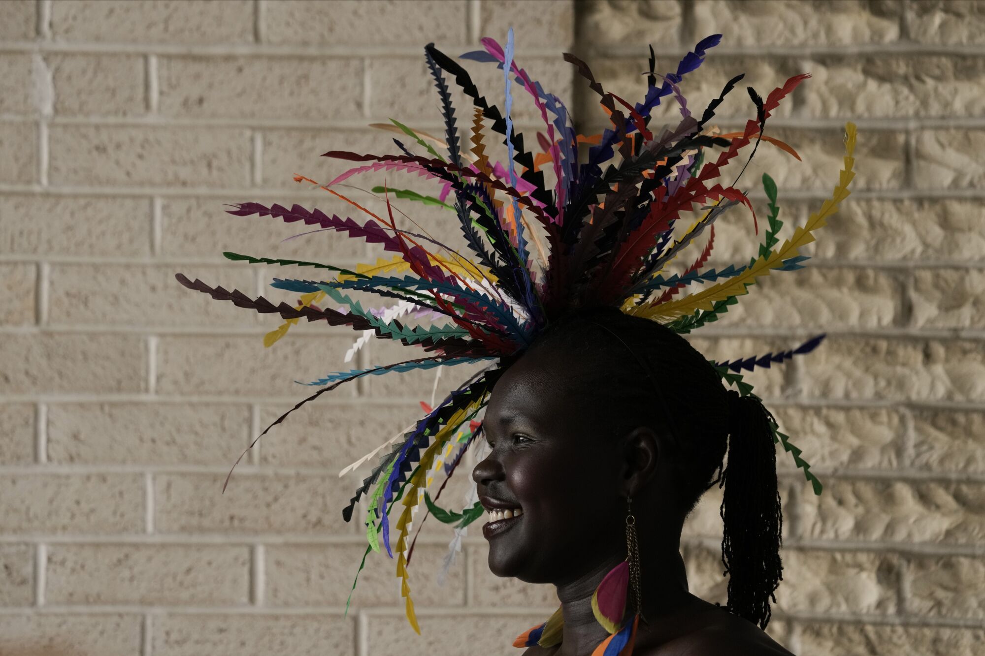 A race fan wears a hat with an elaborate swirl of multi-color ribbons on the grounds of Churchill Downs.