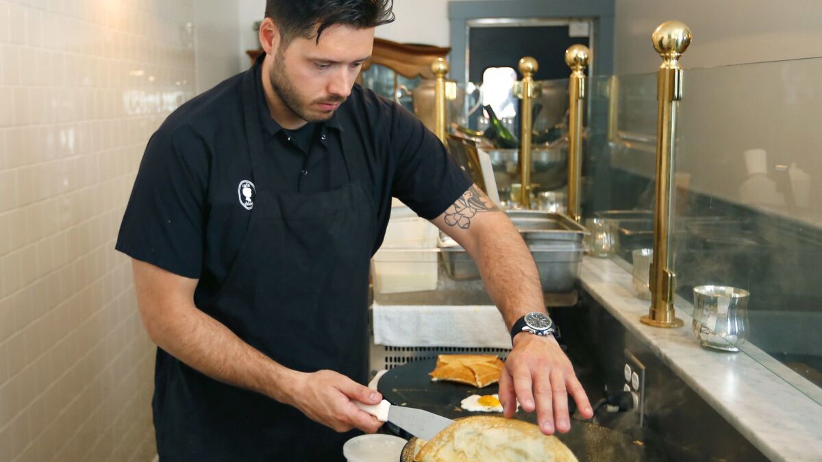 Chef Theo Dimitriou makes crepes at Minou, a Parisian-style creperie, which opened in October in the East Village, shown on April 2, 2018. (Photo by K.C. Alfred/ San Diego Union -Tribune)