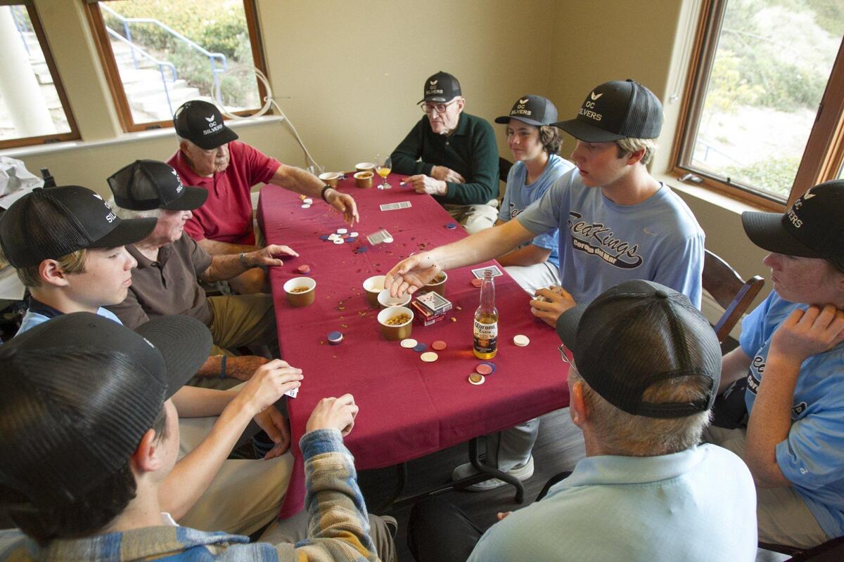 Corona del Mar High School baseball players play a game of 21 with residents at the Crown Cove assisted living facility on March 4. From left are Caden Campbell, Tanner Ivey, Ed Isenberg, Bob Simpson, Charlie Larkin, Kieran Sidebotham, Chase Hartsell and Jesse Ott.