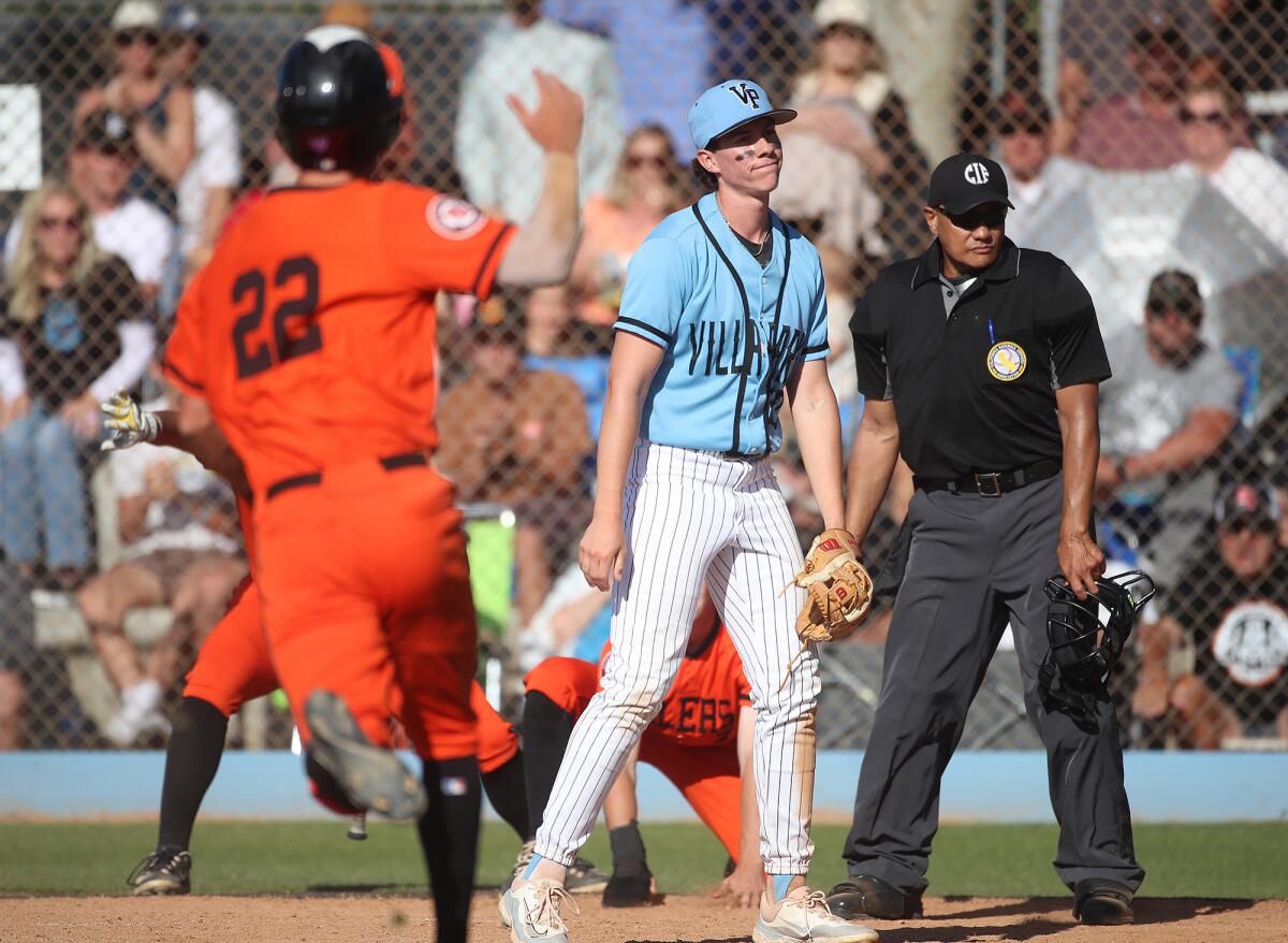 Nate Cox (22) of Huntington Beach runs to home plate to the dismay of Villa Park pitcher Justin Tims after an error.