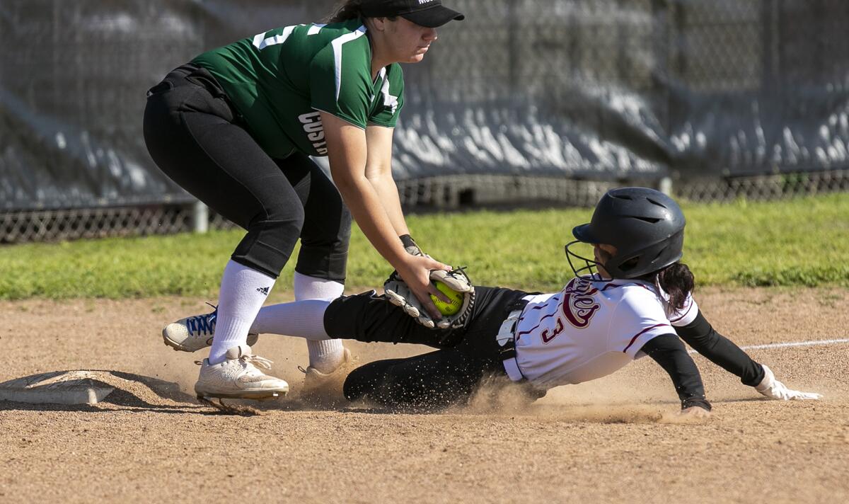 Costa Mesa's Sydnie Pulido tags out Estancia's Devoni Bustos in the fourth inning of the Battle for the Bell game.