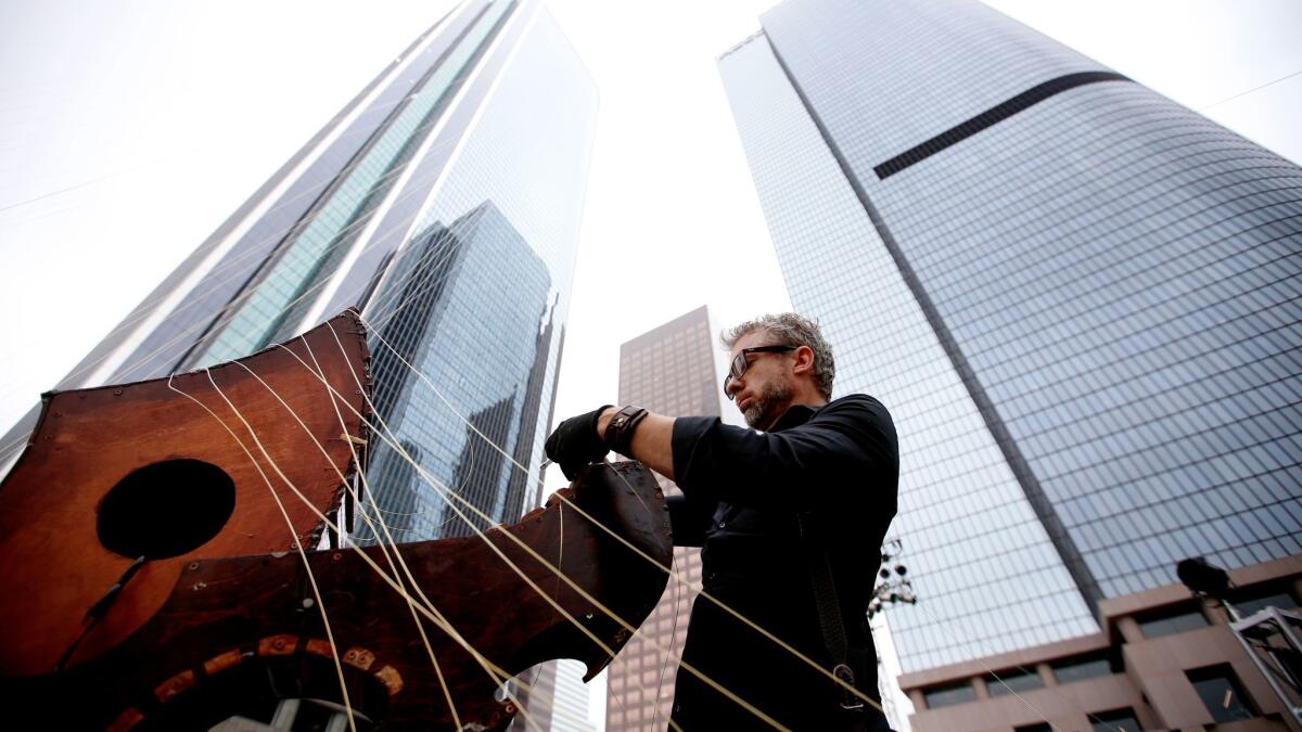 William Close with his Earth Harp, the longest stringed instrument in the world.