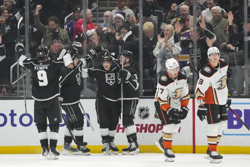 The Los Angeles Kings celebrate after left wing Kevin Fiala (22) scored during the third period of an NHL hockey game against the Anaheim Ducks Tuesday, Dec. 20, 2022, in Los Angeles. (AP Photo/Ashley Landis)