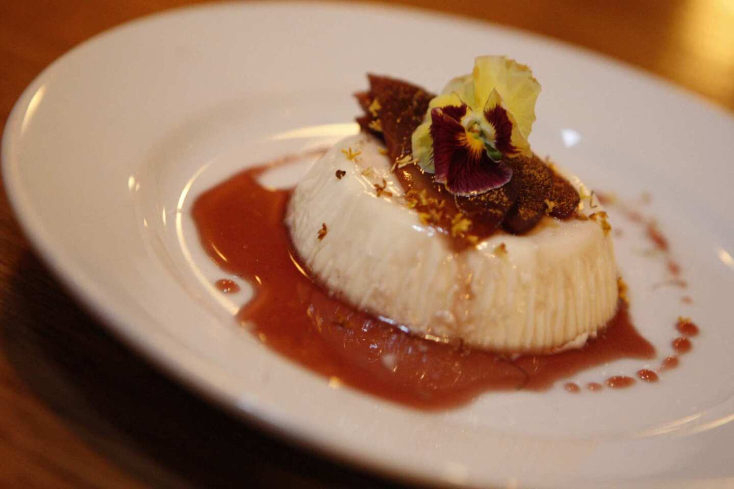 Osmanthus panna cotta with red wine-poached pears.