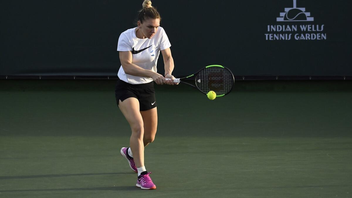 Simona Halep hits a backhand during warm up on practice courts during day three of the BNP Paribas Open on Wednesday in Indian Wells.