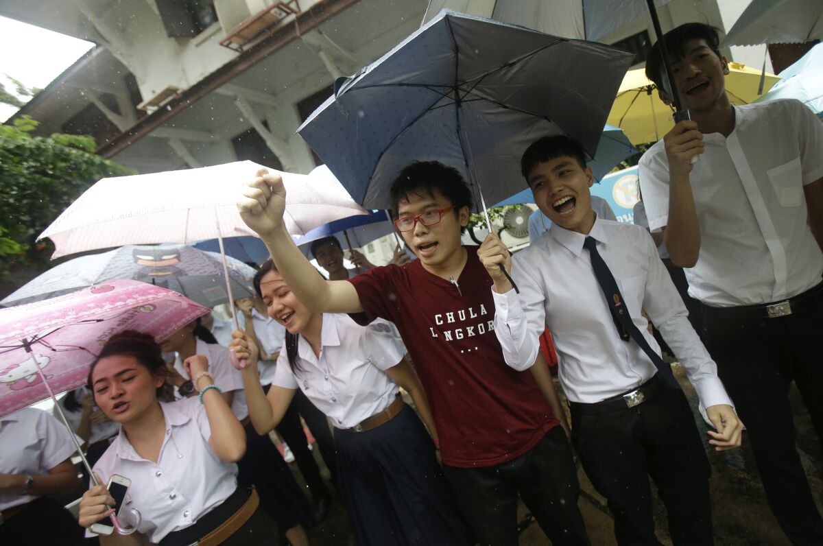 Thai student activists wield umbrellas during a protest in Bangkok in 2016.