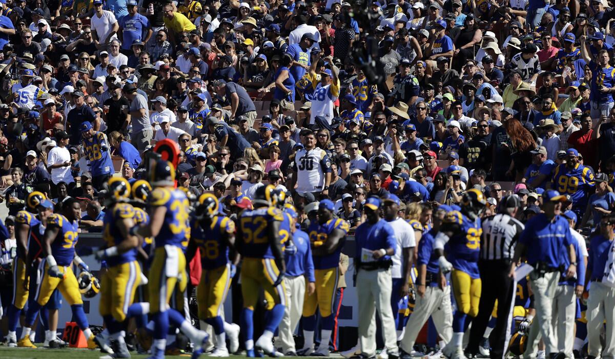 Fans watch the Los Angeles Rams play against Seattle at the Coliseum on Sunday.