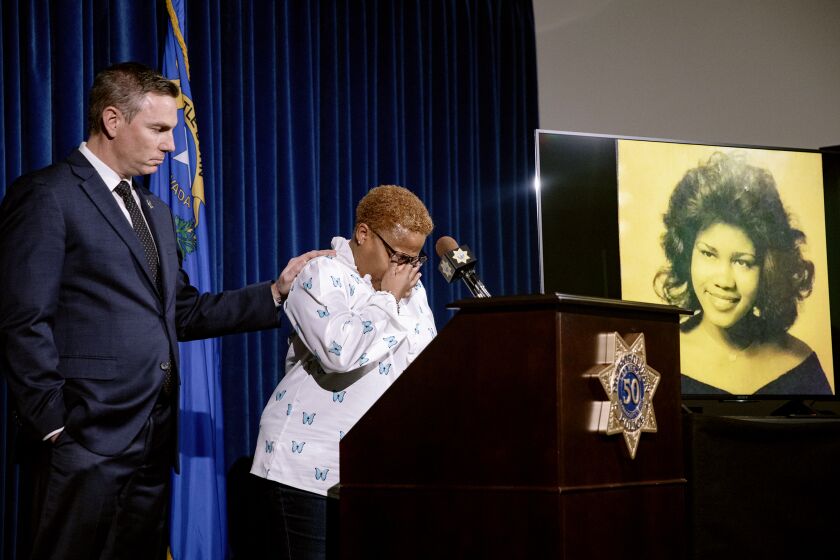 Teresa Board, sister of victim Pearl Wilson Ingram, is comforted by Metropolitan Police Department Lt. Jason Johansson as she talks about her sister's murder at a press conference about the cold case that is now closed after police connected DNA evidence to the killer at Metro Headquarters in Las Vegas, Monday, Feb. 6, 2023. (Rachel Aston/Las Vegas Review-Journal via AP)