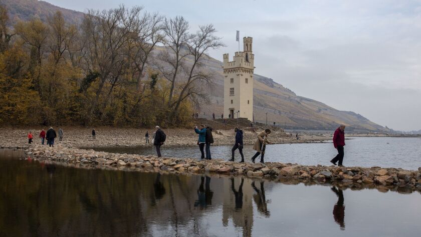 Visitors crossed the Rhine River on foot in early November to visit Mouse Tower in the town of Bingen, Germany. The historic low water level allowed people to walk to the tower usually surrounded by water.