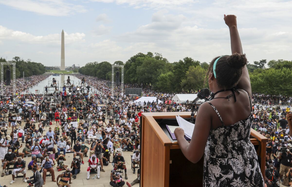  In this Friday, Aug. 28, 2020, file photo, Yolanda Renee King raises her fist as she speaks.