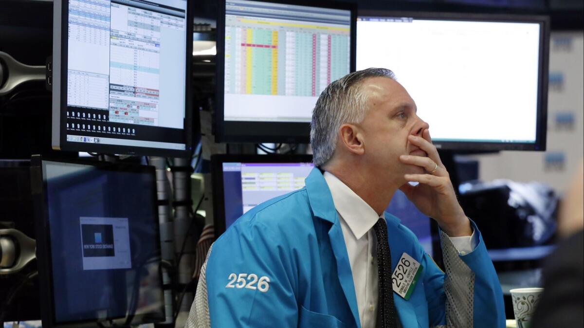 Specialist Donald Himpele Jr. works at his post on the floor of the New York Stock Exchange on Monday.