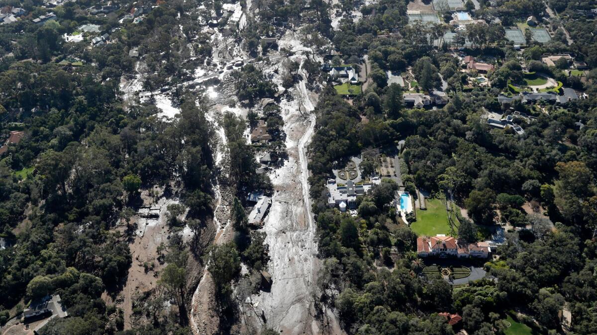 Mud and debris surrounds homes in Montecito on Wednesday.