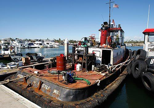 The tug boat Joedy docks at Newport Dunes Marina after it crashed once into Pearson's Port fresh fish market while pulling a dredge barge and also the Newport Beach Pacific Coast Highway Bridge, reportedly several times, over the past five weeks, according to the U.S. Coast Guard. The tug, which has seen better days, was ordered to cease operations.