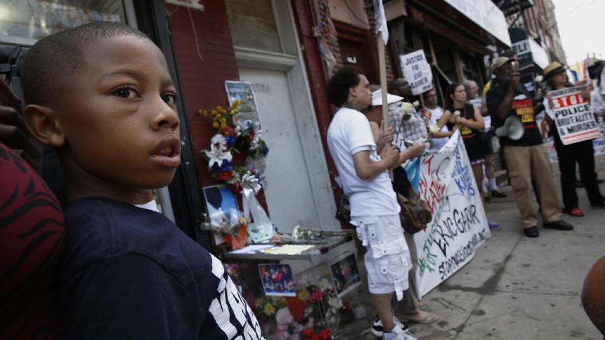 People gather in July 2015 at the Staten Island memorial site for Eric Garner on the one-year anniversary of his death.