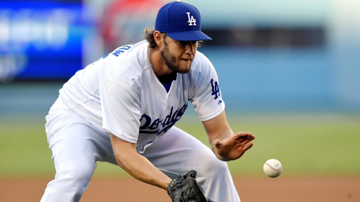 Dodgers starter Clayton Kershaw fields a ball hit by the Mets' Juan Lagares during a game on July 3 at Dodger Stadium.