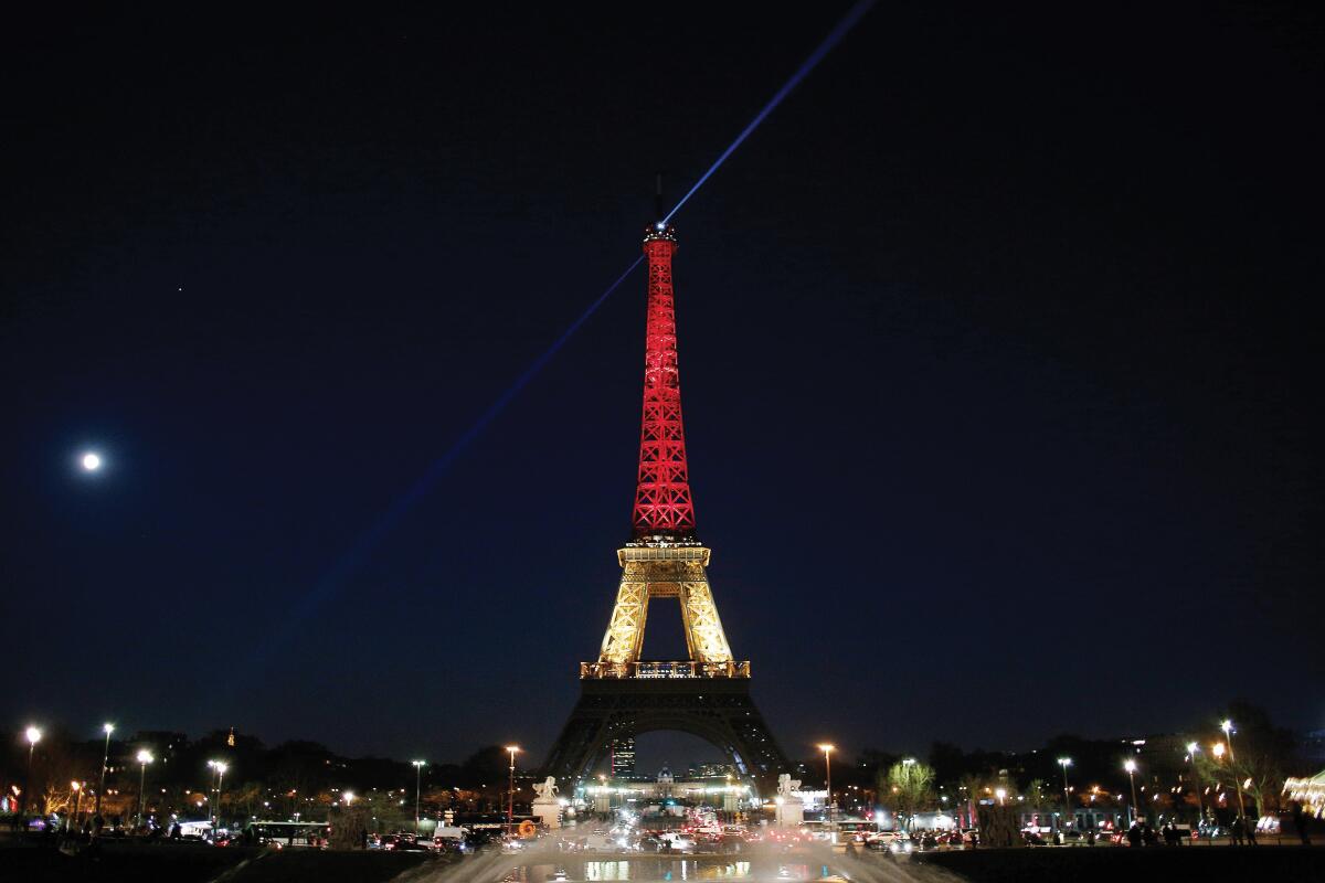 A giant tower shines a light at night.