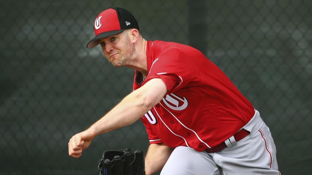 Alex Wood pitches at the Cincinnati Reds spring training facility in Goodyear, Ariz.