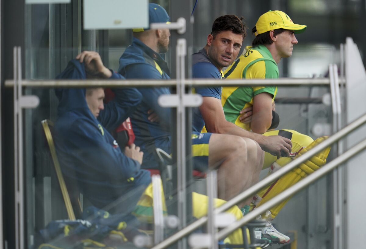 Australia's Marcus Stoinis, second right, sits with the teammates in the balcony as they watch the game during the first ODI cricket match between England and Australia, at Old Trafford in Manchester, England, Friday, Sept. 11, 2020. (AP Photo/Jon Super, Pool)