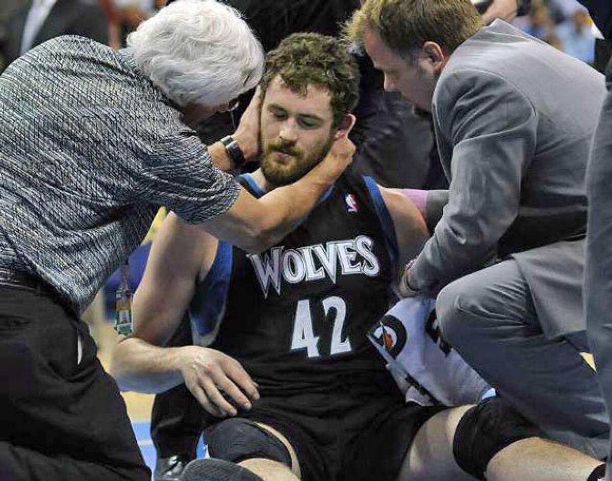 Kevin Love is examined by a doctor after he took a shot to the head during an April 11 game.