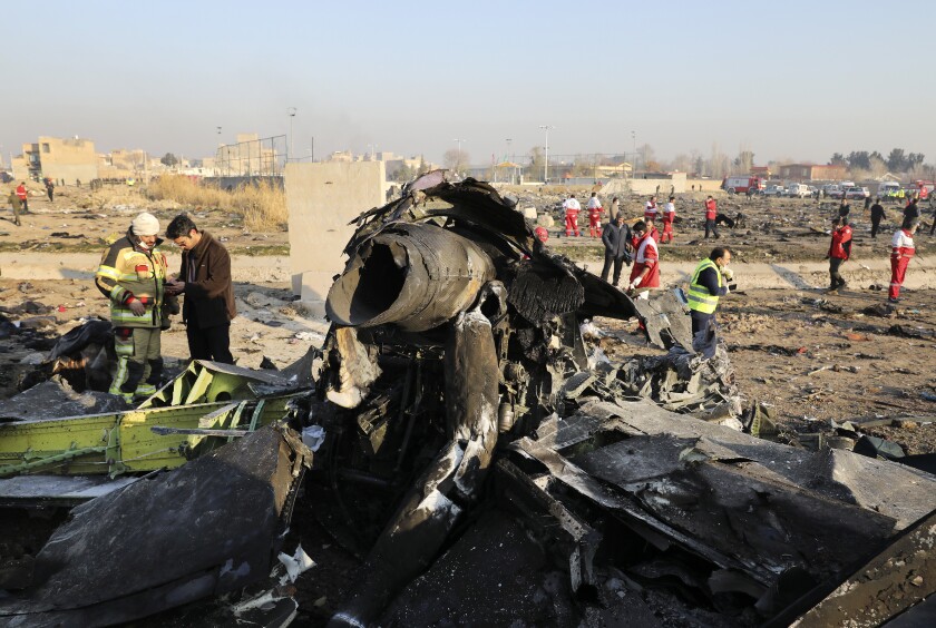 In this Wednesday, Jan. 8, 2020 file photo debris at the scene where a Ukrainian plane crashed in Shahedshahr southwest of the capital Tehran, Iran. Two U.S. officials said Thursday that it was “highly likely” that an Iranian anti-aircraft missile downed a Ukrainian jetliner late Tuesday, killing all 176 people on board. President Donald Trump is suggesting he believes Iran was responsible. (AP Photo/Ebrahim Noroozi)