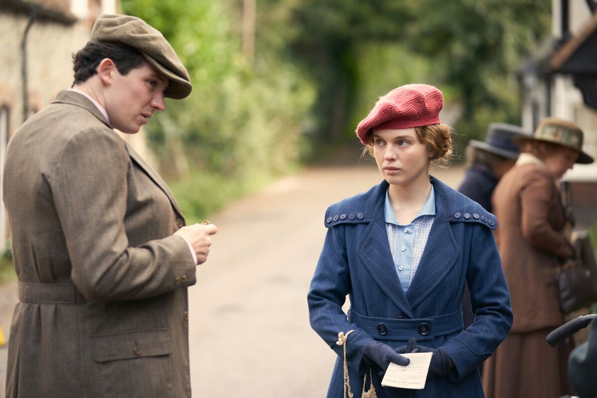 A young man and a young woman dressed in 1924 period clothing in the movie "Mothering Sunday."