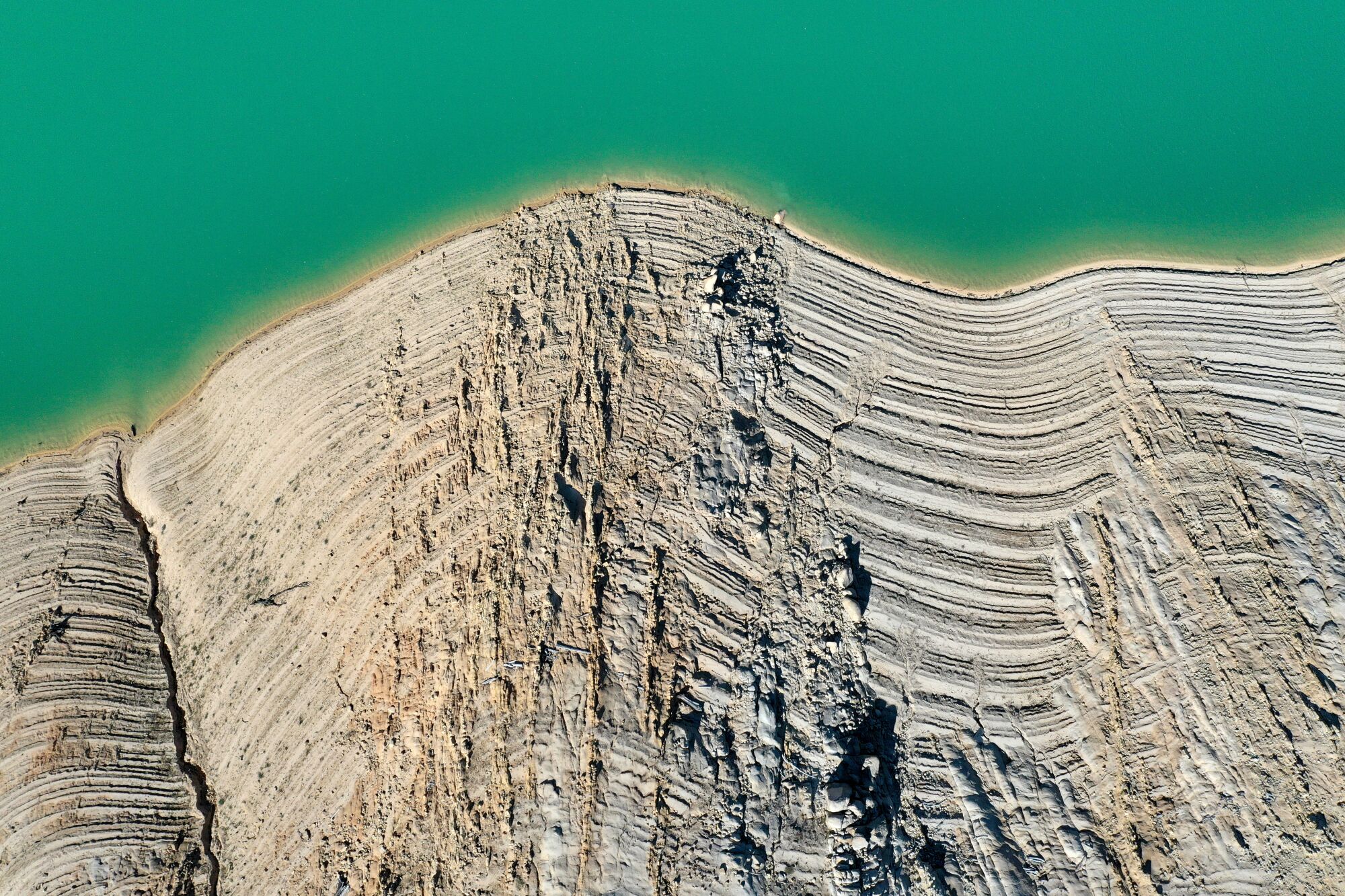 Water lines are visible on the steep banks of Lake Oroville.