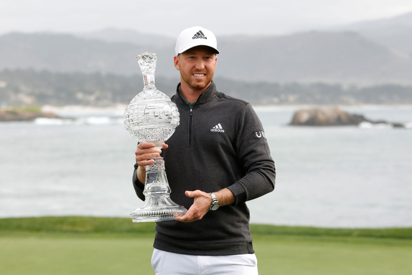 Daniel Berger celebrates with the winner's trophy after claiming victory at the Pebble Beach Pro-Am on Sunday.