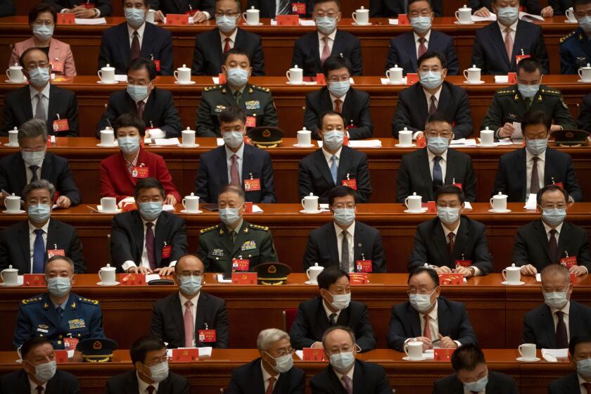 Delegates wearing face masks sit before the opening session of the 20th National Congress of China's ruling Communist Party in Beijing, China, Sunday, Oct. 16, 2022. As China's ruling Communist Party holds a major congress this week, many Beijing residents are wondering if the end of the meeting will bring any easing of China's draconian "zero-COVID" policies that are disrupting lives and the economy. (AP Photo/Mark Schiefelbein)