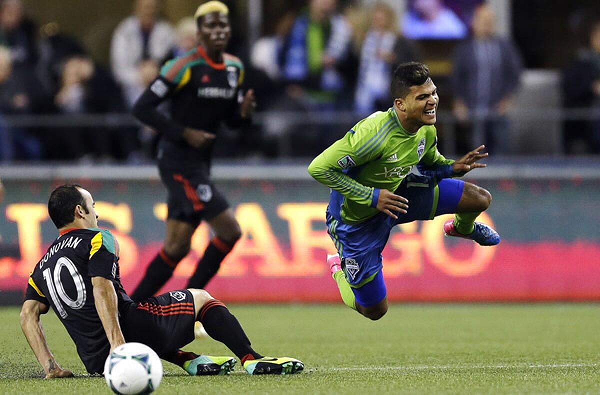 Galaxy midfielder Landon Donovan sends the Sounders' DeAndre Yedlin flying with a sliding tackle in the first half Sunday.