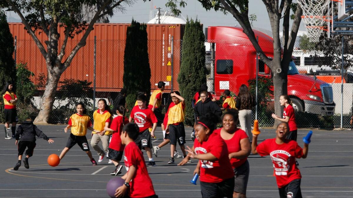 Students play at Elizabeth Hudson K-8 School next to the Terminal Island Freeway in Long Beach.