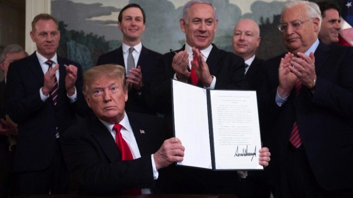 President Trump holds up a signed proclamation on the Golan Heights alongside Israeli Prime Minister Benjamin Netanyahu at the White House on March 25.
