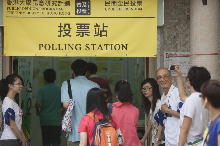 Hong Kong residents vote in a nonbinding referendum on universal suffrage at a polling station in the New Territories region of Hong Kong on June 22.