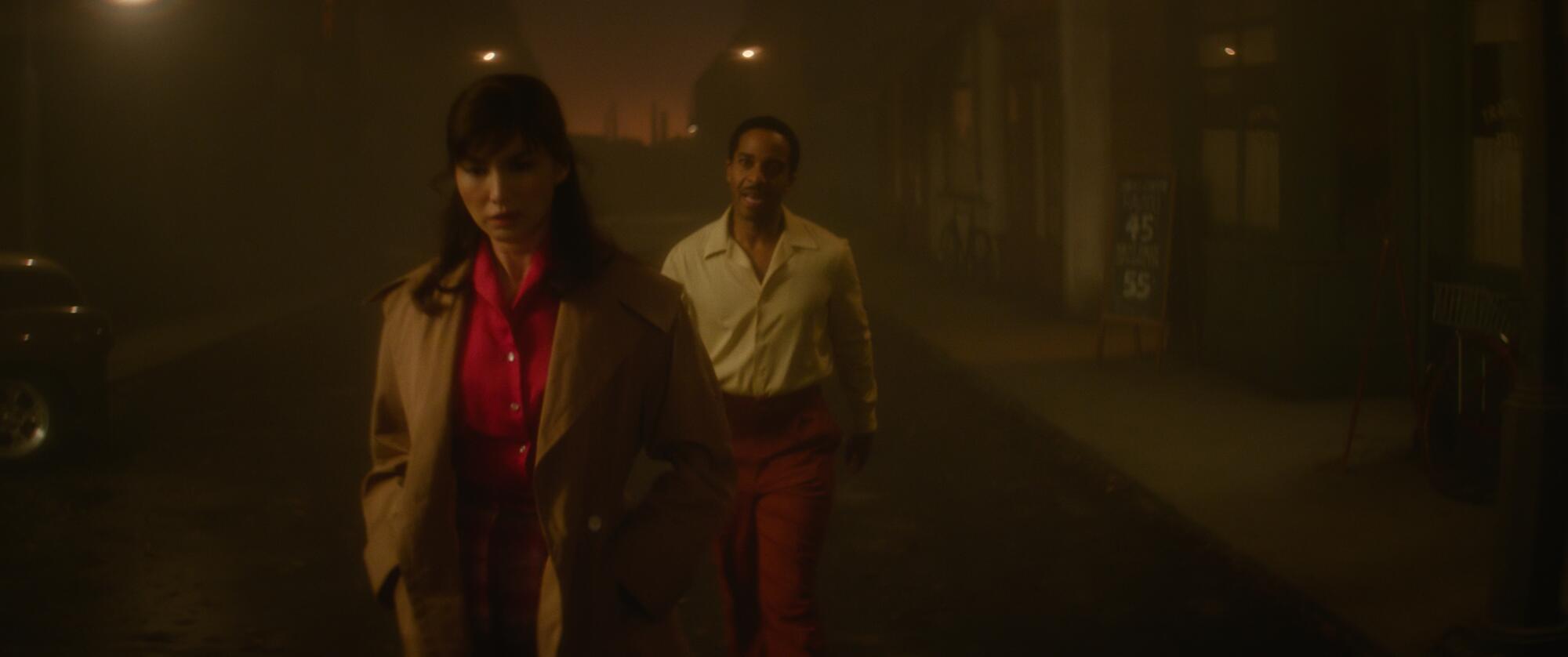 A man speaks to a woman walking away on a mysterious street.