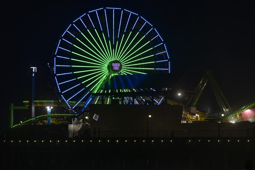 The Pacific Park's solar-powered Ferris wheel spins at Santa Monica Pier for Earth Day, Monday, April 22, 2024, in Santa Monica, Calif. (AP Photo/Damian Dovarganes)